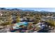 Overhead shot of community pools, cabanas, and landscaping amid houses and desert landscape at 7261 E Norland St, Mesa, AZ 85207