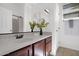 Clean bathroom with a modern vanity, decorative plant, and well-lit mirror at 7261 E Norland St, Mesa, AZ 85207