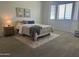 Bedroom featuring a neutral color palette, textured rug, cozy furnishings, and bright natural light at 7261 E Norland St, Mesa, AZ 85207