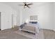 Bright carpeted bedroom featuring neutral decor, a ceiling fan and 2 large closets at 7261 E Norland St, Mesa, AZ 85207