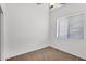 Well-lit bedroom with plush carpet and a window at 7261 E Norland St, Mesa, AZ 85207