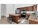 Bright kitchen featuring stainless appliances, brown cabinetry and a kitchen island with seating at 7261 E Norland St, Mesa, AZ 85207