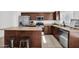 Eat-in kitchen boasts stainless steel appliances, and a center island with seating at 7261 E Norland St, Mesa, AZ 85207
