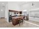 Modern kitchen features a stainless steel refrigerator and a center island with stool seating at 7261 E Norland St, Mesa, AZ 85207