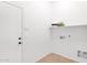 Bright laundry room featuring tile floors, storage and a folding area at 7261 E Norland St, Mesa, AZ 85207