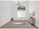 Large living room boasts a contemporary chandelier, tall ceilings, and great natural light at 7261 E Norland St, Mesa, AZ 85207