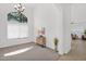 Spacious living room with tall ceilings, large window, and stylish chandelier at 7261 E Norland St, Mesa, AZ 85207
