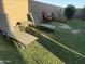Relaxing backyard featuring lounge chairs on green grass with a brick wall providing privacy and shade at 7321 S 48Th Dr, Laveen, AZ 85339