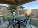 Inviting backyard showcasing an outdoor dining area, a grill, and lush green lawn, ideal for relaxation at 7321 S 48Th Dr, Laveen, AZ 85339