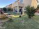 Spacious backyard featuring a covered patio, verdant lawn, and outdoor seating, perfect for leisure and entertainment at 7321 S 48Th Dr, Laveen, AZ 85339