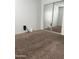 Cozy bedroom with brown carpeting and a mirrored sliding door closet, offering a comfortable living space at 7321 S 48Th Dr, Laveen, AZ 85339