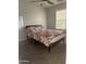 Neutral bedroom with a bed dressed in a floral comforter, complemented by light streaming through the window at 7321 S 48Th Dr, Laveen, AZ 85339