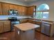 Well-equipped kitchen with wooden cabinets, stainless steel appliances, and a center island at 7321 S 48Th Dr, Laveen, AZ 85339