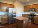 Well-equipped kitchen with wooden cabinets, stainless steel appliances, and a center island at 7321 S 48Th Dr, Laveen, AZ 85339