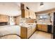 Classic kitchen features wood cabinets, vintage appliances, and a view into the living area with a fireplace at 736 E Loyola Dr, Tempe, AZ 85282