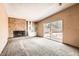 Cozy living room with stone fireplace, built-in shelving, and sliding glass doors to the backyard at 736 E Loyola Dr, Tempe, AZ 85282