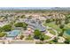 Aerial view of the club featuring a restaurant, a tennis court, and a pond at 7401 W Arrowhead Club Dr # 2067, Glendale, AZ 85308