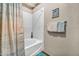 Clean bathroom featuring a bathtub with shower and tile walls at 7401 W Arrowhead Club Dr # 2067, Glendale, AZ 85308