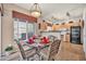 Cozy dining area with modern light fixture, seating for four, and views to the kitchen at 7401 W Arrowhead Club Dr # 2067, Glendale, AZ 85308
