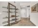 Hallway with carpet and tile flooring, decorative shelving, and neutral paint at 7401 W Arrowhead Club Dr # 2067, Glendale, AZ 85308
