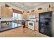 Bright kitchen featuring tiled floors, black appliances, and ample counter space at 7401 W Arrowhead Club Dr # 2067, Glendale, AZ 85308