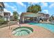 Community pool area includes a hot tub, shaded seating, and poolside lounge chairs at 7401 W Arrowhead Club Dr # 2067, Glendale, AZ 85308