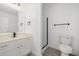 Bright bathroom with granite vanity, black fixtures, and glass shower door at 8478 W Grovers Ave, Peoria, AZ 85382