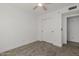 Bedroom with ceiling fan, closet, and light neutral carpet at 8478 W Grovers Ave, Peoria, AZ 85382