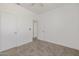 Bedroom with light neutral carpet and two separate doors at 8478 W Grovers Ave, Peoria, AZ 85382