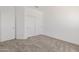 Bedroom featuring neutral carpet and a closet with sliding doors at 8478 W Grovers Ave, Peoria, AZ 85382