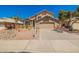 Charming two-story home with a well-maintained front yard, desert landscaping, and a two-car garage at 8478 W Grovers Ave, Peoria, AZ 85382