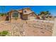 Two-story home features desert landscaping, a two-car garage, and a well-manicured front yard at 8478 W Grovers Ave, Peoria, AZ 85382