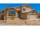 Home features desert landscaping, a two-car garage, and a well-manicured front yard at 8478 W Grovers Ave, Peoria, AZ 85382