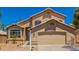 Attractive home exterior features a well-manicured yard and a two-car garage for convenient parking at 8478 W Grovers Ave, Peoria, AZ 85382