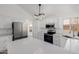 Bright kitchen featuring stainless steel appliances and quartz countertops at 8478 W Grovers Ave, Peoria, AZ 85382
