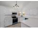 Bright kitchen with white cabinetry, stainless steel appliances, and quartz countertops at 8478 W Grovers Ave, Peoria, AZ 85382