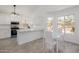 Bright, updated kitchen features stainless steel appliances, quartz countertops, and a cozy breakfast nook with backyard view at 8478 W Grovers Ave, Peoria, AZ 85382