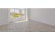 Bright and spacious living room with tile floors and a large picture window framing the neighborhood view at 8478 W Grovers Ave, Peoria, AZ 85382