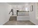 Open living space with a stairway leading to the kitchen and tiled floors at 8478 W Grovers Ave, Peoria, AZ 85382