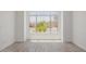 Bright, open living space with large window offering neighborhood views and tiled floors at 8478 W Grovers Ave, Peoria, AZ 85382