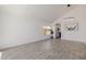 Open-concept living area with ample space, tiled flooring, and an arched entryway at 8478 W Grovers Ave, Peoria, AZ 85382