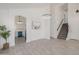 Open-concept living space with stairs, kitchen access, and decorative lighting features at 8478 W Grovers Ave, Peoria, AZ 85382