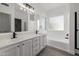Bright bathroom featuring a double sink vanity, and a soaking tub at 8478 W Grovers Ave, Peoria, AZ 85382