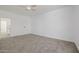Spacious bedroom with neutral carpet, ceiling fan, and closet access at 8478 W Grovers Ave, Peoria, AZ 85382