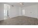 Spacious bedroom with neutral carpet, ceiling fan, and access to main bathroom at 8478 W Grovers Ave, Peoria, AZ 85382
