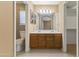 Bathroom features a dual sink vanity with a large mirror and plenty of cabinet storage space at 8876 W Bluefield Ave, Peoria, AZ 85382