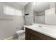 Bathroom showcasing dark wood vanity, updated fixtures, a mirror, and a window for natural light at 8876 W Bluefield Ave, Peoria, AZ 85382