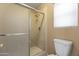 Bathroom featuring a glass shower door and window, providing ample natural light at 8876 W Bluefield Ave, Peoria, AZ 85382