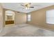 Carpeted primary bedroom with ensuite bathroom and large window at 8876 W Bluefield Ave, Peoria, AZ 85382