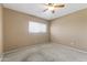 Bedroom featuring tan carpet, neutral walls, ceiling fan, and window for lots of light at 8876 W Bluefield Ave, Peoria, AZ 85382